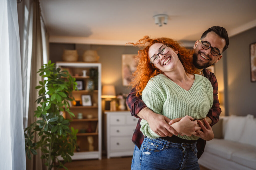 Couple embracing at home after learning unexpected pregnant news at Home.